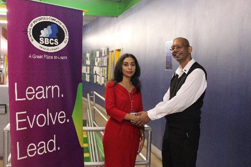 Ms Yacub is congratulated by her lecturer Mr Karmalain Manohar