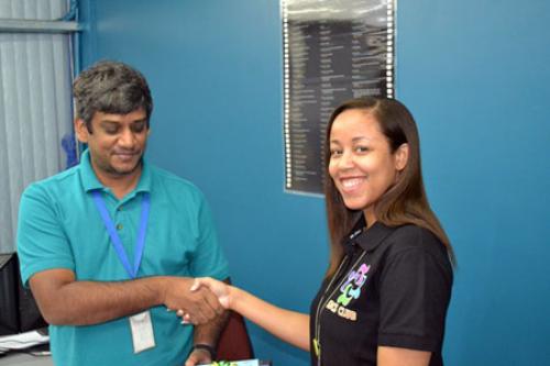  SBCS Club Event Co-ordinator distributes a Father's Day token to a staff member