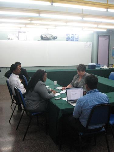 Lecturers & Dr. Cooper engrossed in brainstorming session
