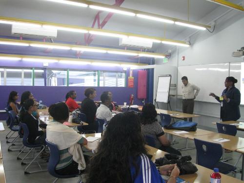 Ms. Althea Boucaud, Senior Student Services Administrator welcomes participants at the Negotiating Tips & Techniques session  