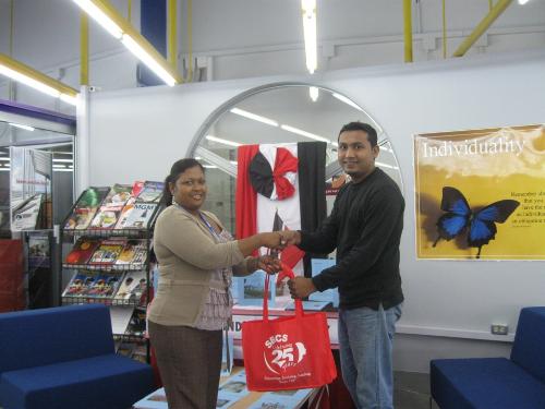 Sharon Beharry presents Vijay Deonarine with his SBCS token